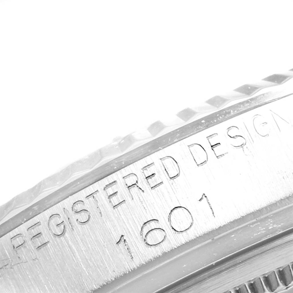 The image shows a close-up of the serial number and part of the bezel on a Rolex Vintage Collection 1601 Men's Stainless Steel Silver Dial 1601 Men's Stainless Steel Silver Dial model.