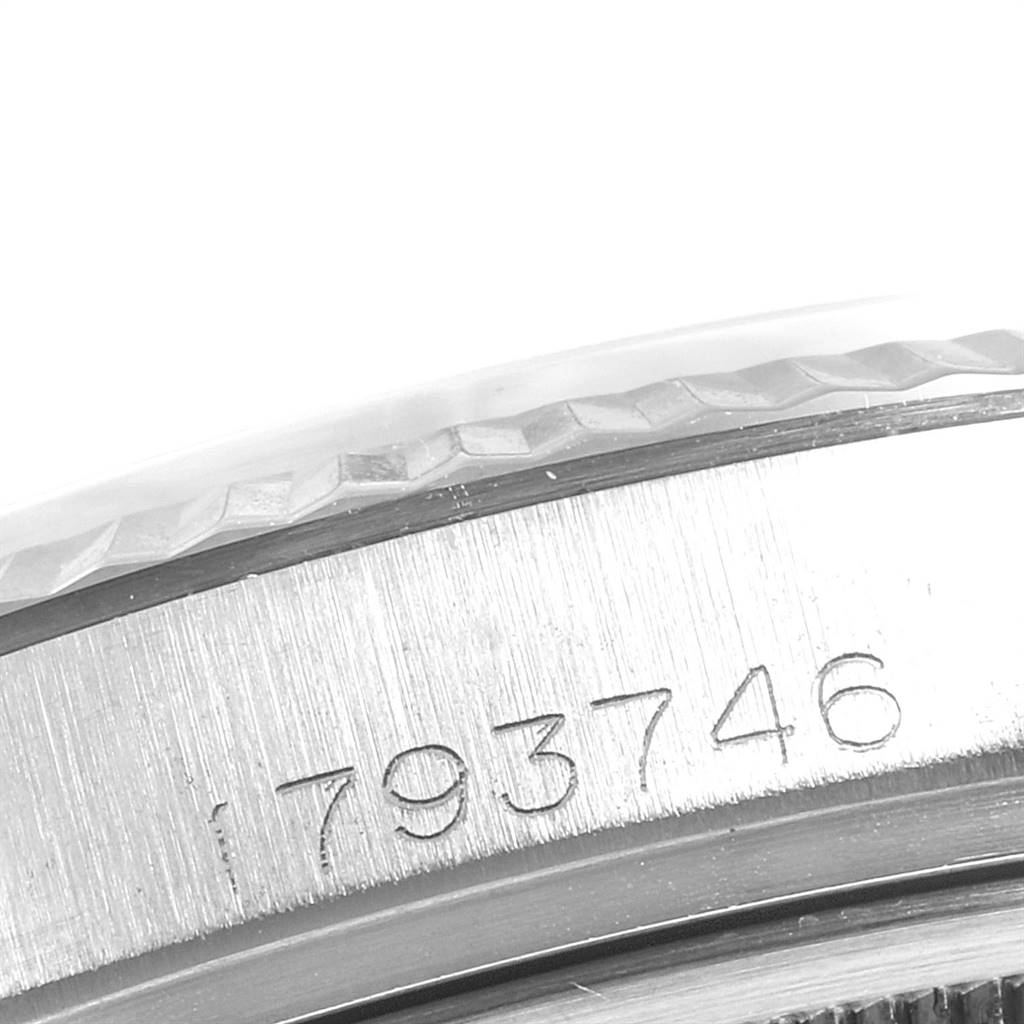 This image shows a close-up of the serial number and the bezel edge of a Vintage Collection Rolex watch.