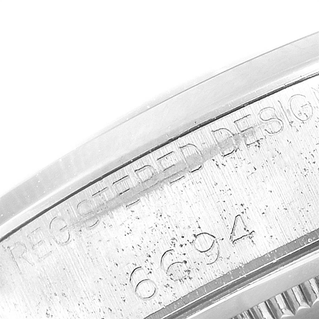 The image shows a close-up of the side case engraving on the Vintage Collection model by Rolex, featuring the design registration and model number.