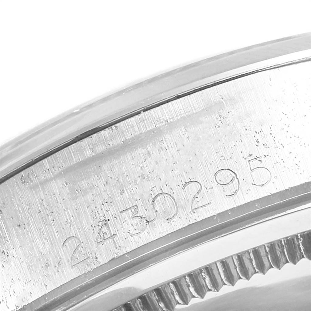 This close-up image of the Rolex Vintage Collection 6694 Men's Stainless Steel Blue Dial 6694 Men's Stainless Steel Blue Dial watch focuses on the serial number engraved on the side of the case.