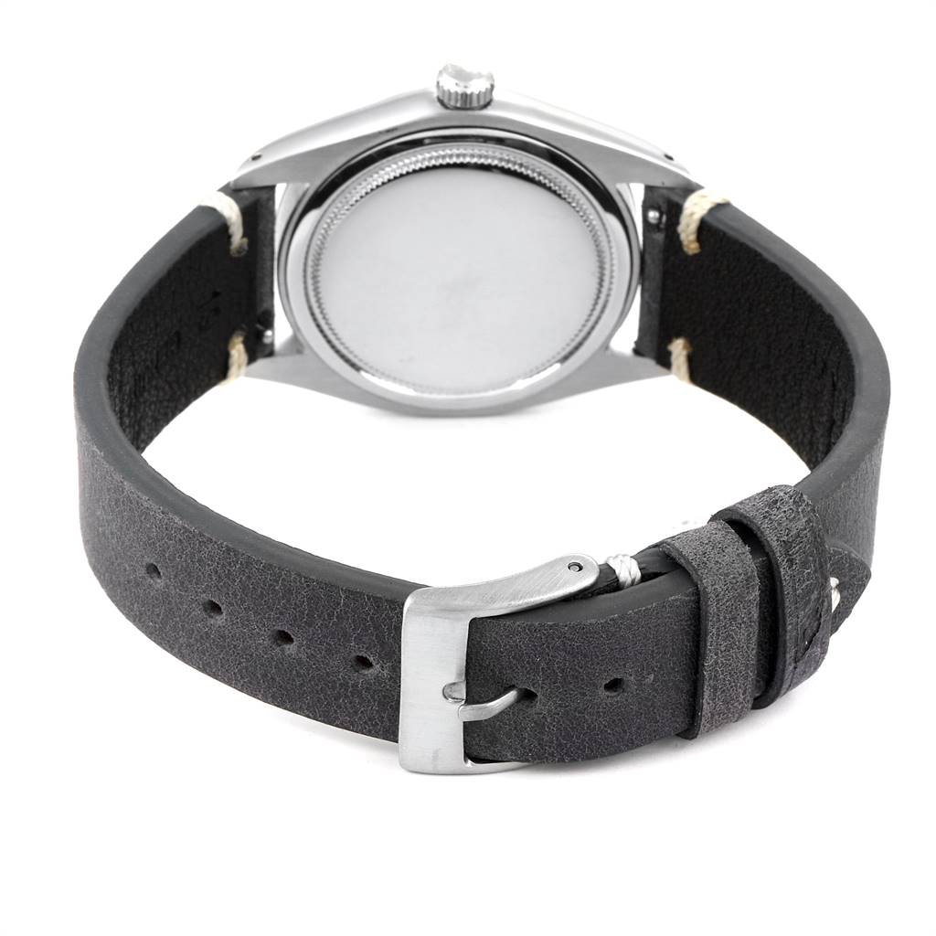 The image shows the back case and black leather strap of the Rolex Vintage Collection 6694 Men's Stainless Steel Blue Dial 6694 Men's Stainless Steel Blue Dial watch placed face down.