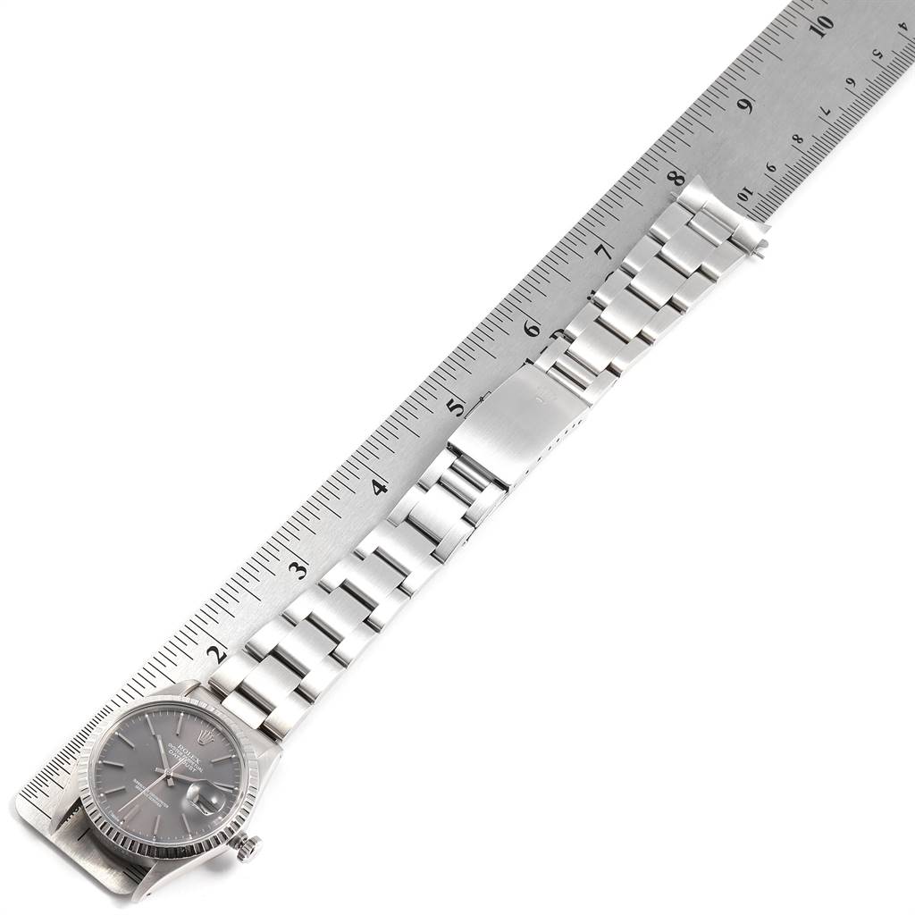 The image shows a Rolex Vintage Collection 16030 Men's Stainless Steel Grey Dial 16030 Men's Stainless Steel Grey Dial watch from an overhead angle, displaying the watch face, the full bracelet, and its clasp alongside a measuring ruler.