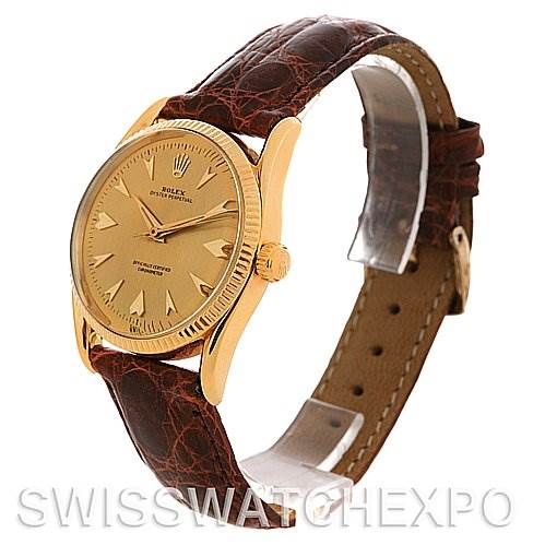 This image shows a side angle of the Rolex Vintage Collection 6593 Men's Yellow Gold Champagne Dial 6593 Men's Yellow Gold Champagne Dial watch, displaying its gold case, dial, crown, and brown leather strap.