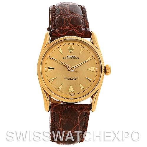 The image shows a front view of a Rolex Vintage Collection 6593 Men's Yellow Gold Champagne Dial 6593 Men's Yellow Gold Champagne Dial watch with a gold dial and brown leather strap.
