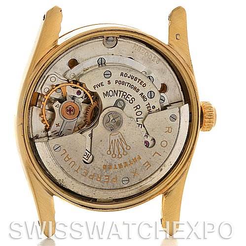 The image shows the inner workings and mechanical movement of a Vintage Collection Rolex watch from the back angle.