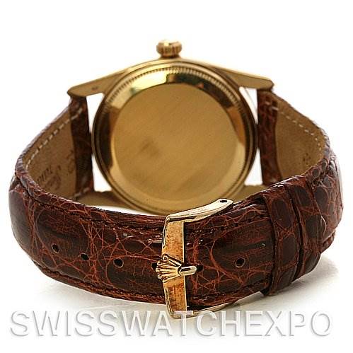 This image shows the back view of a Vintage Collection Rolex watch, highlighting its leather strap and gold buckle.