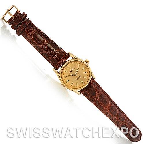 The image shows a top view of a Rolex Vintage Collection 6593 Men's Yellow Gold Champagne Dial 6593 Men's Yellow Gold Champagne Dial watch with a brown leather strap and a gold face.