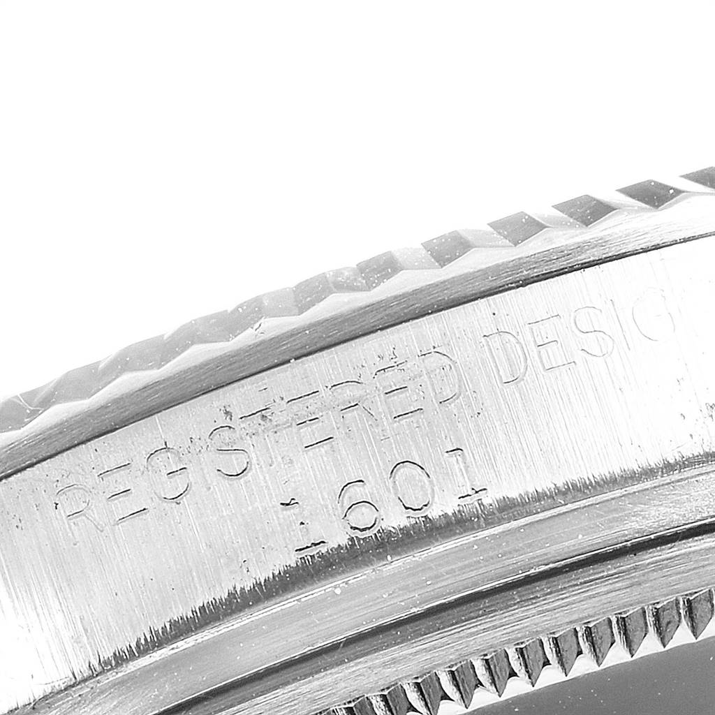 This close-up image of the Rolex Vintage Collection 1601 Men's Stainless Steel Silver Dial 1601 Men's Stainless Steel Silver Dial model shows the engraved watch case with the text "REGISTERED DESIGN 1601".