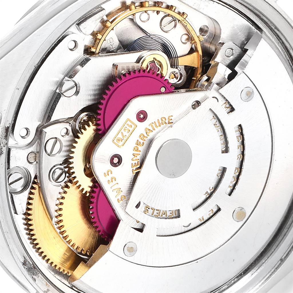 This close-up image shows the intricate inner mechanism of a Rolex Vintage Collection 1500 Men's Stainless Steel Silver Dial 1500 Men's Stainless Steel Silver Dial watch, highlighting the gears and rotor.