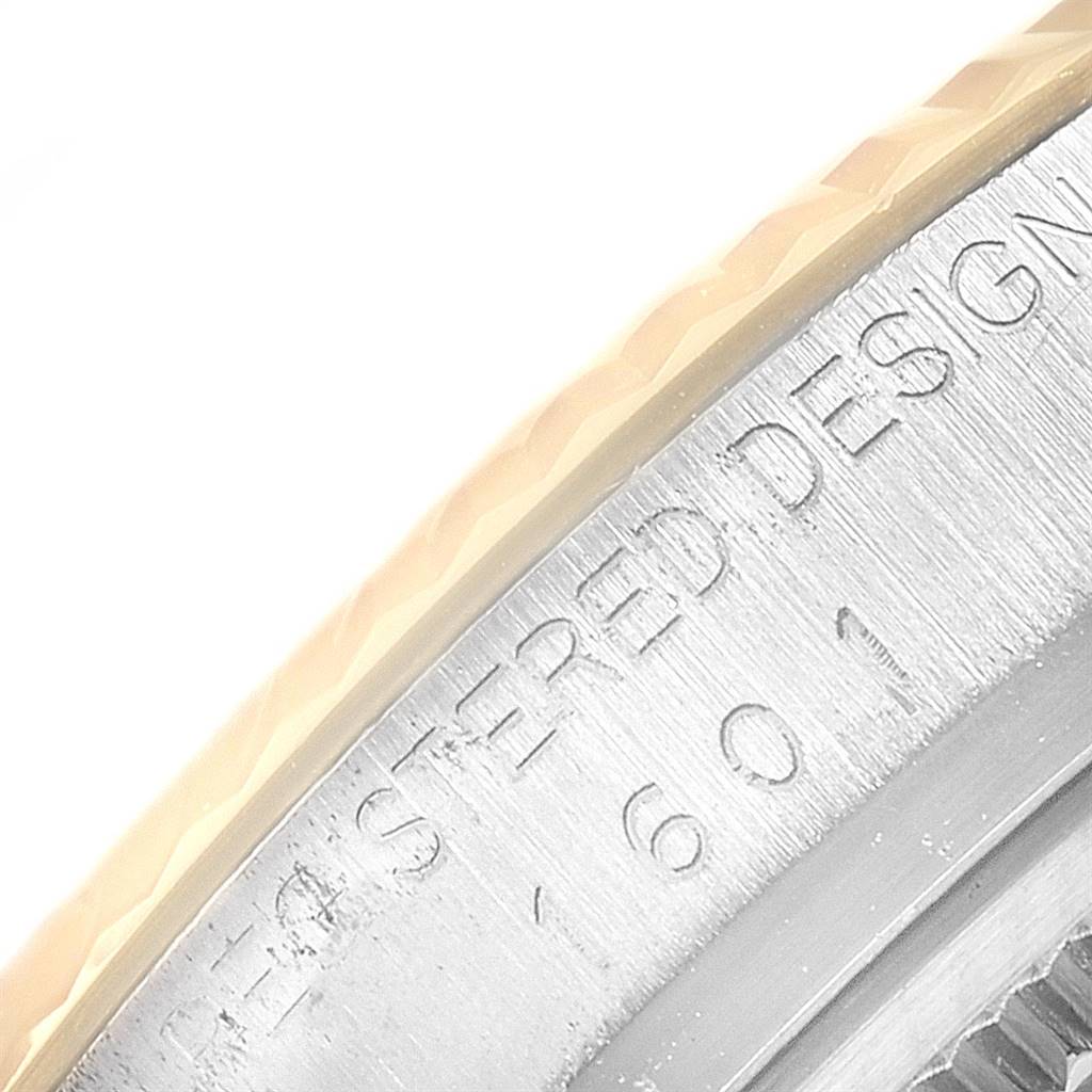 This close-up shows the engraved edge of the Vintage Collection model by Rolex, focusing on the bezel and part of the case.