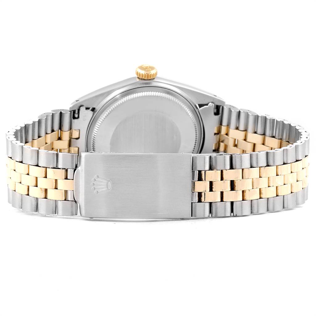 The image shows the back view of a Rolex Vintage Collection 1601 Men
s Steel and Gold (two tone) Silver Dial 1601 Men
s Steel and Gold (two tone) Silver Dial watch, highlighting the case back, crown, and two-tone bracelet clasp.