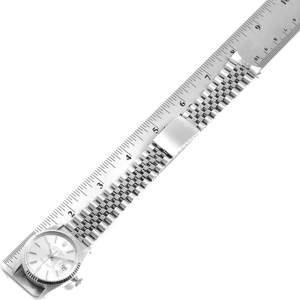 The image shows a Rolex Vintage Collection 16014 Men's Stainless Steel Silver Dial 16014 Men's Stainless Steel Silver Dial watch laid flat next to a ruler, displaying the watch face and metal bracelet.