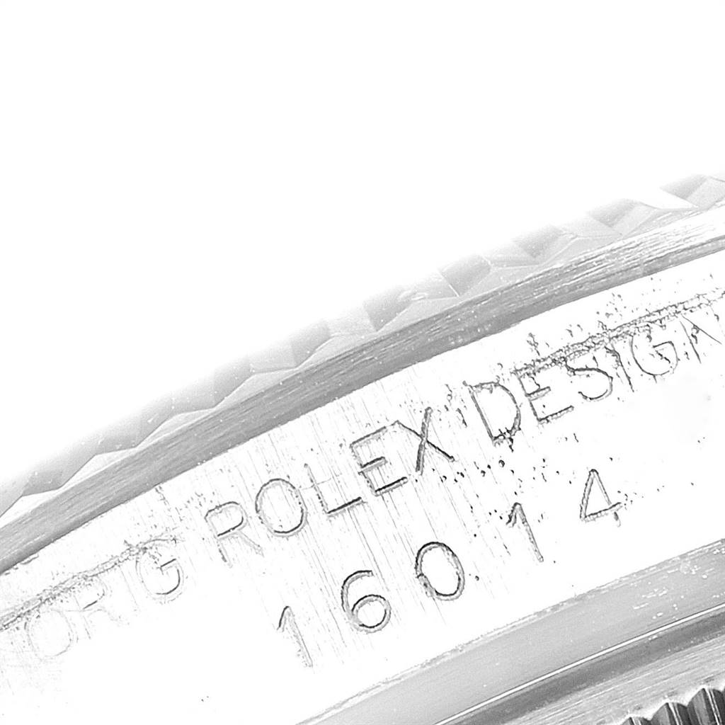 This image shows a close-up of the serial number engraving on the bezel of the Rolex Vintage Collection 16014 Men's Stainless Steel Silver Dial 16014 Men's Stainless Steel Silver Dial model.