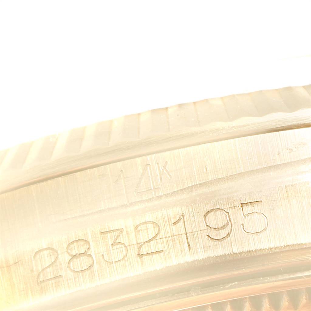 The image shows a close-up of the serial number and 14k gold marking on the bezel of a Vintage Collection Rolex watch.