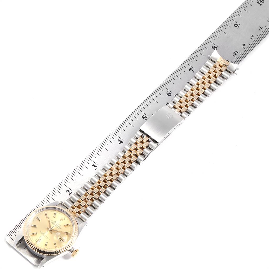 The image shows the Rolex Vintage Collection 16013 Men's Stainless Steel Champagne Dial 16013 Men's Stainless Steel Champagne Dial watch with its full bracelet, clasp, and part of the face, measured alongside a ruler.