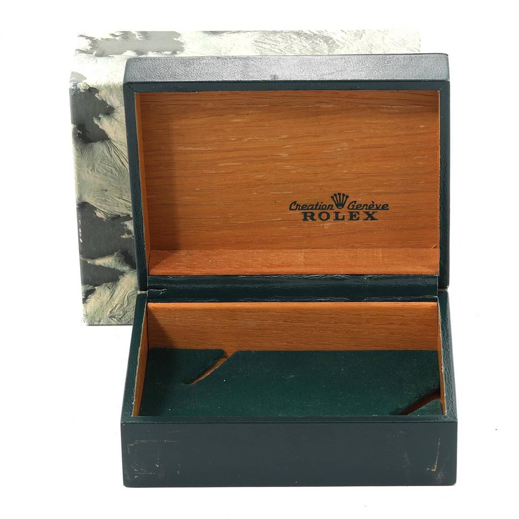 This is an open wooden watch box for the Vintage Collection model by Rolex with green interior lining.