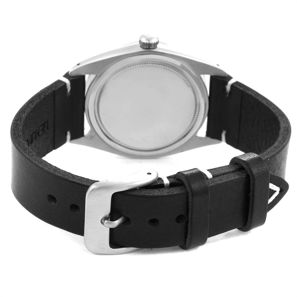 The image shows the back view of a Vintage Collection Rolex watch with its leather strap and buckle.