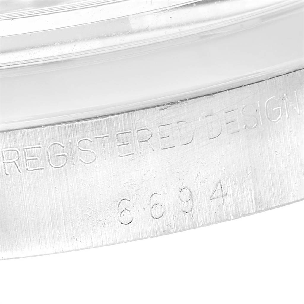 This close-up image shows the case edge with engraved details of a Rolex Vintage Collection 6694 Men's Stainless Steel Silver Dial 6694 Men's Stainless Steel Silver Dial model watch.