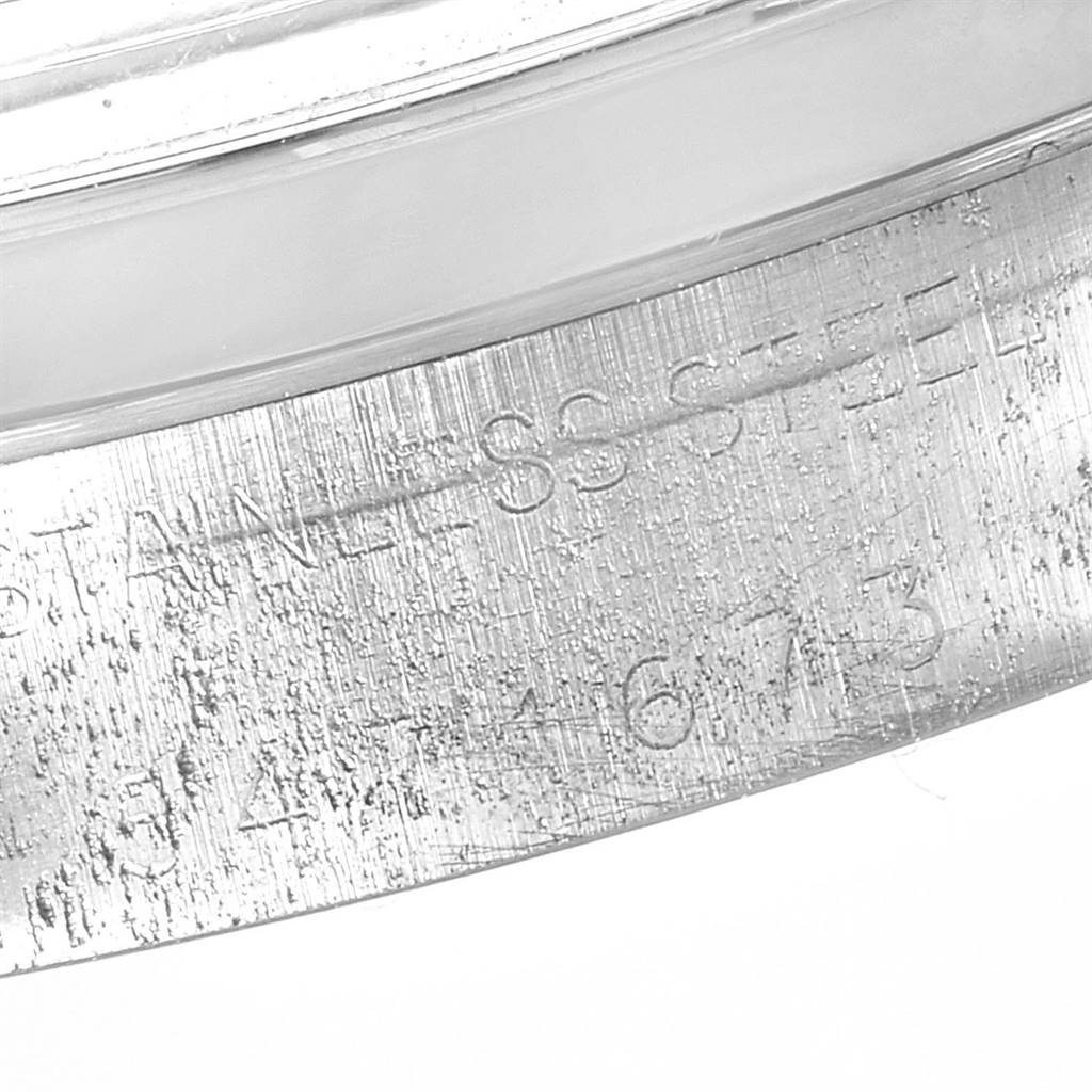 The image shows a close-up of the case back edge of a Rolex Vintage Collection 6694 Men's Stainless Steel Silver Dial 6694 Men's Stainless Steel Silver Dial model, revealing the engraved serial and model numbers.