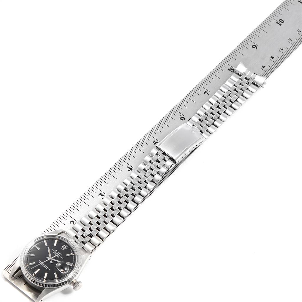 The Vintage Collection Rolex watch is displayed flat with the face, metal bracelet, and clasp visible, measured against a ruler.
