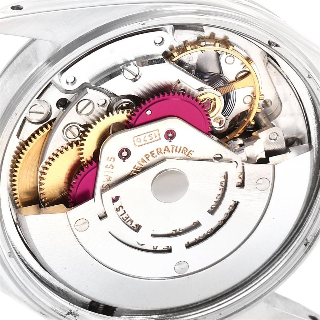 The image shows the intricate internal gears and mechanism of the Rolex Vintage Collection 1601 Men
s Stainless Steel Black Dial 1601 Men
s Stainless Steel Black Dial watch.