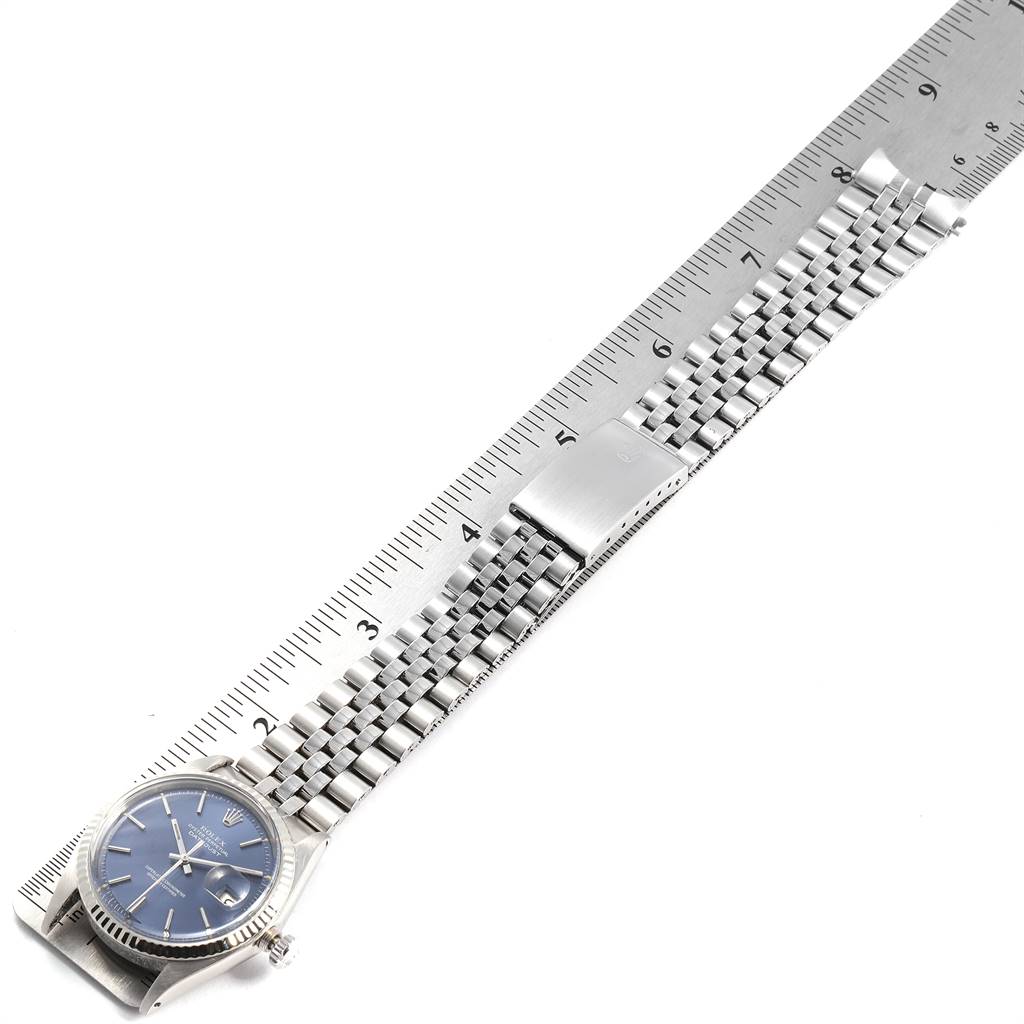 The image shows a flat, angled view of the Rolex Vintage Collection 1601 Men's Stainless Steel Blue Dial 1601 Men's Stainless Steel Blue Dial watch with its bracelet extended alongside a ruler.