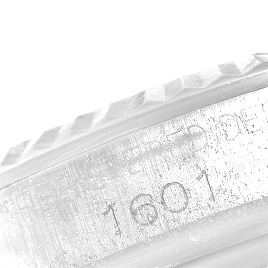 This close-up image shows the serial number area and partial bezel of a Rolex Vintage Collection 1601 Men's Stainless Steel Blue Dial 1601 Men's Stainless Steel Blue Dial model watch.