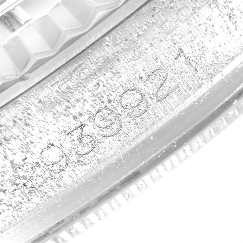 The image shows an extreme close-up of the serial number engraving on the side of the case for the Rolex Vintage Collection 1601 Men's Stainless Steel Blue Dial 1601 Men's Stainless Steel Blue Dial model.