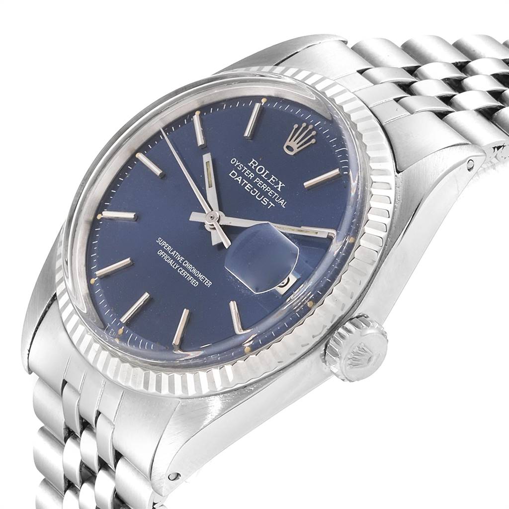 The Vintage Collection Rolex watch is shown from a front-angle, highlighting its blue dial, bezel, crown, and Jubilee bracelet.