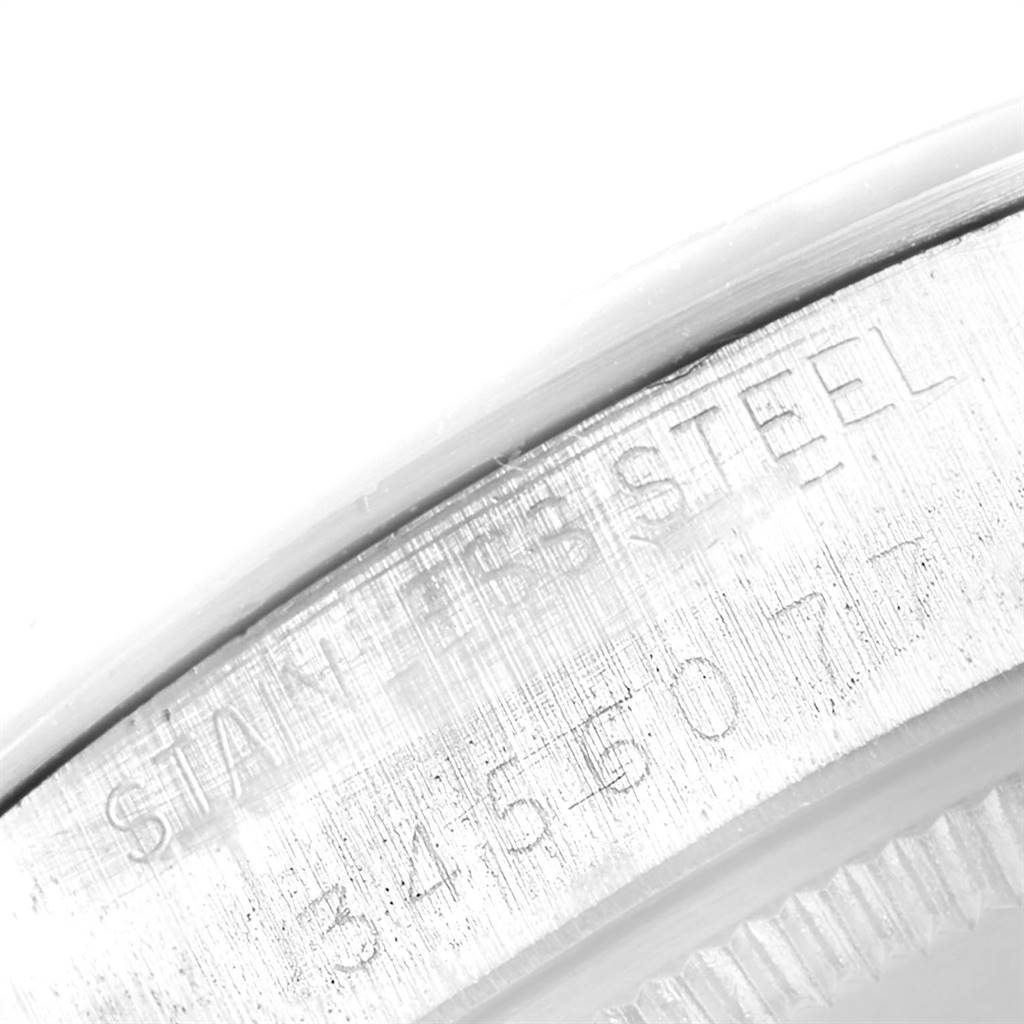 This image shows a close-up of the stainless steel case and serial number of a Vintage Collection Rolex watch.