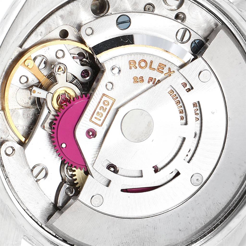 This image shows a close-up of the inner mechanism of a Vintage Collection Rolex watch, highlighting its intricate gears and parts.