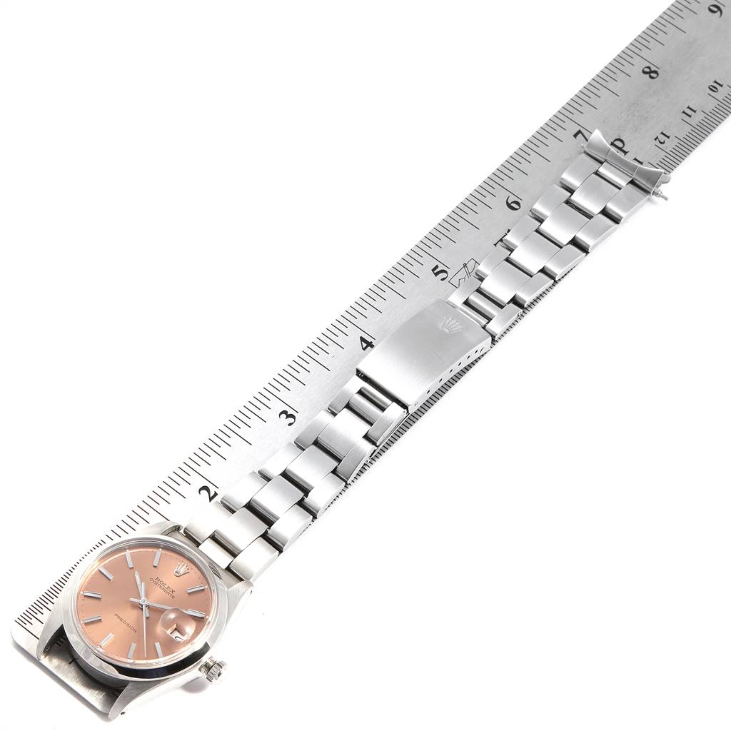 The image shows a Rolex Vintage Collection 6694 Men's Stainless Steel Pink Dial 6694 Men's Stainless Steel Pink Dial watch laying flat, showcasing its dial and stainless steel bracelet against a ruler for size reference.