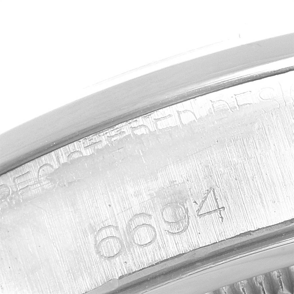 The image shows a close-up of the caseback and engraved serial number of the Rolex Vintage Collection 6694 Men's Stainless Steel Pink Dial 6694 Men's Stainless Steel Pink Dial model.