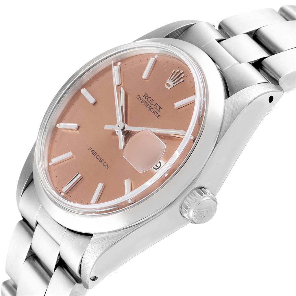 The image shows a close-up of the Rolex Vintage Collection 6694 Men's Stainless Steel Pink Dial 6694 Men's Stainless Steel Pink Dial watch face, its crown, and part of its metal bracelet.