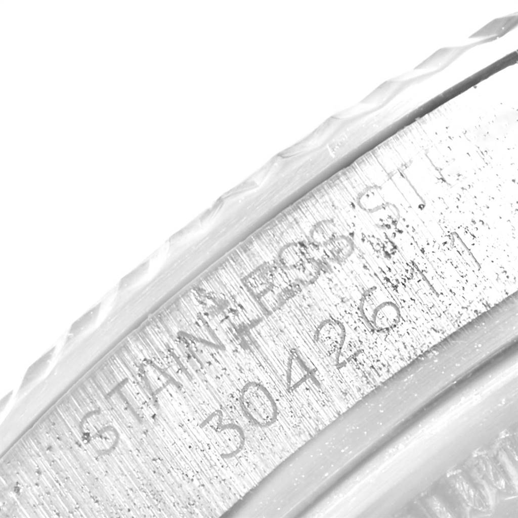 This is a close-up of the edge of a Vintage Collection Rolex watch, showing part of its stainless steel engraving and serial number.