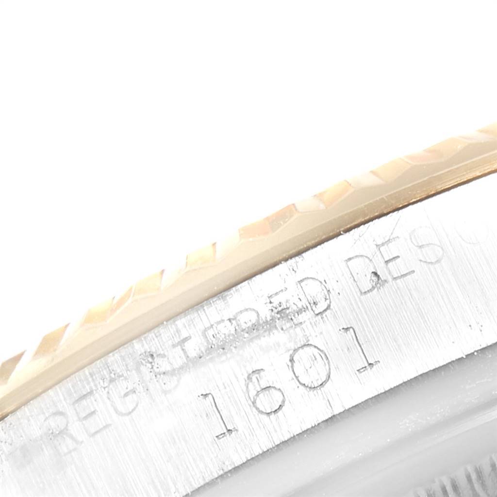 This close-up image of the Rolex Vintage Collection 1601 Men's Steel and Gold (two tone) Brown Dial 1601 Men's Steel and Gold (two tone) Brown Dial model shows part of the watch bezel and serial number "1601" on the case.