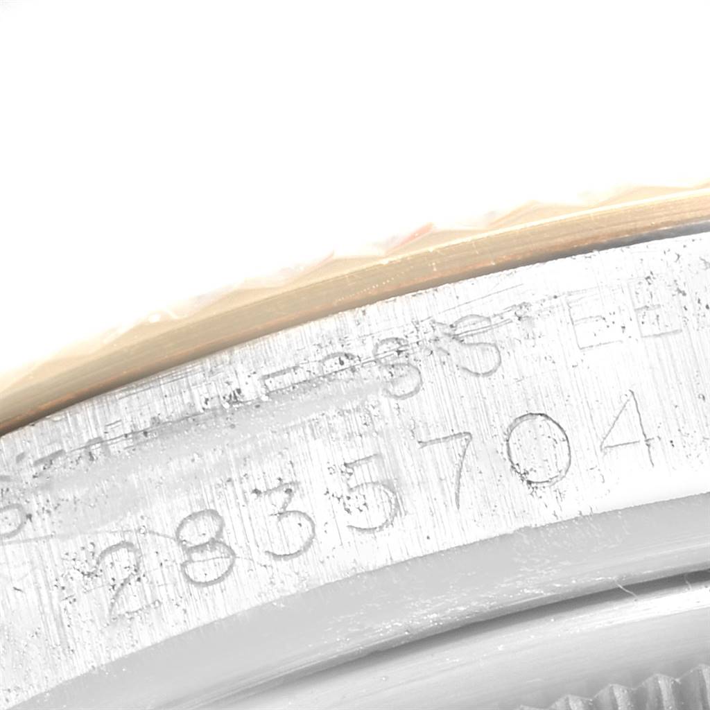 This close-up image shows the serial number engraved on the metal casing of a Vintage Collection Rolex watch.