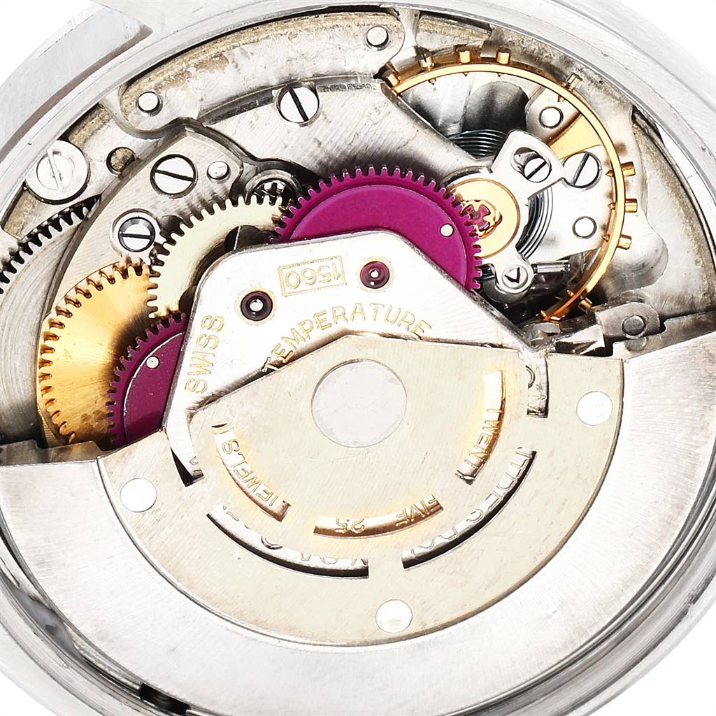 The image shows an internal view of the movement mechanism of the Rolex Vintage Collection 1002 Men
s Stainless Steel Silver Dial 1002 Men
s Stainless Steel Silver Dial watch, displaying gears and intricate components.