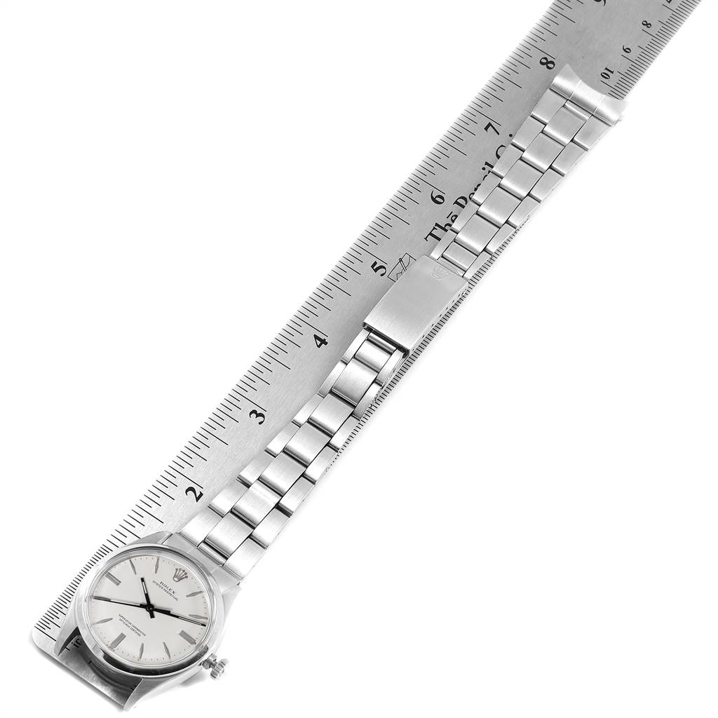 The image shows a Rolex Vintage Collection 1002 Men's Stainless Steel Silver Dial 1002 Men's Stainless Steel Silver Dial watch placed next to a ruler, displaying the face and entire metal strap.