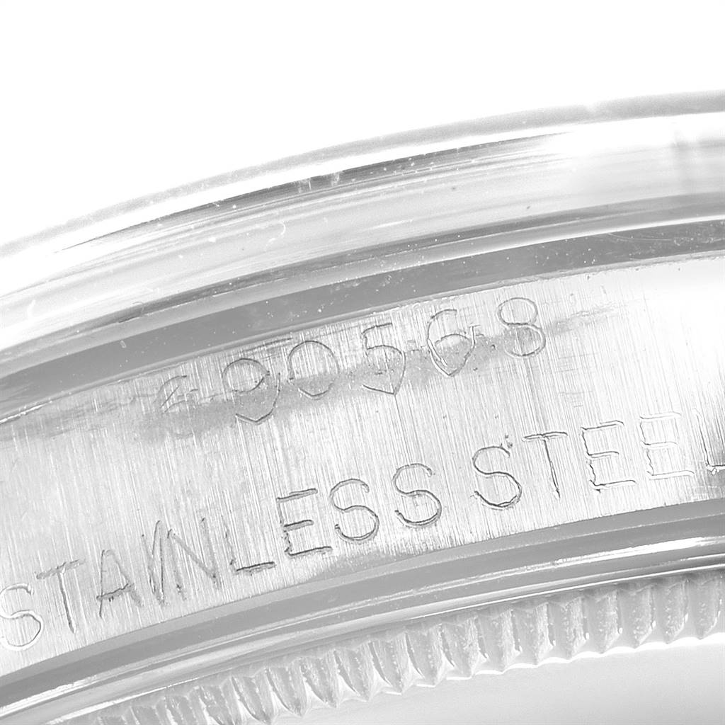 This is a close-up view of the stainless steel casing for the Rolex Vintage Collection 1002 Men's Stainless Steel Silver Dial 1002 Men's Stainless Steel Silver Dial watch, showing engravings and part of the bezel.