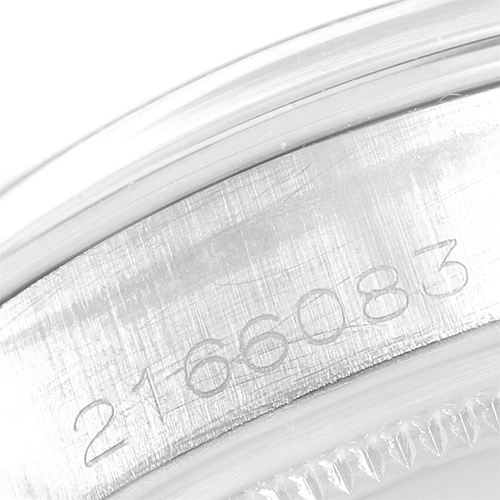 The image shows an extreme close-up of the serial number on the case side of a Rolex Vintage Collection 5500 Men
s Stainless Steel Black Dial 5500 Men
s Stainless Steel Black Dial model watch.