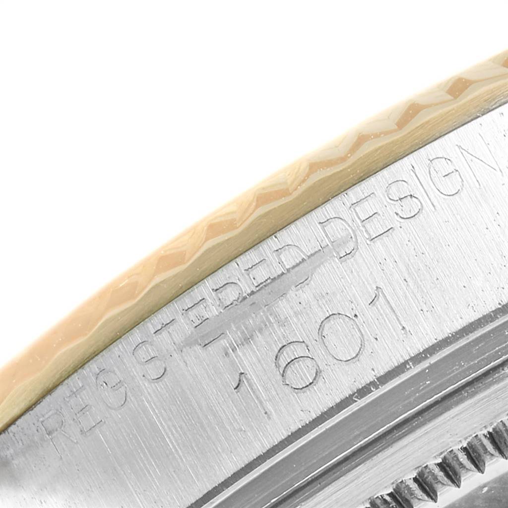 The image shows a close-up of the side of a Rolex Vintage Collection 1601 Men's Steel and Gold (two tone) Silver Dial 1601 Men's Steel and Gold (two tone) Silver Dial watch model 1601, highlighting the bezels and engraved text.