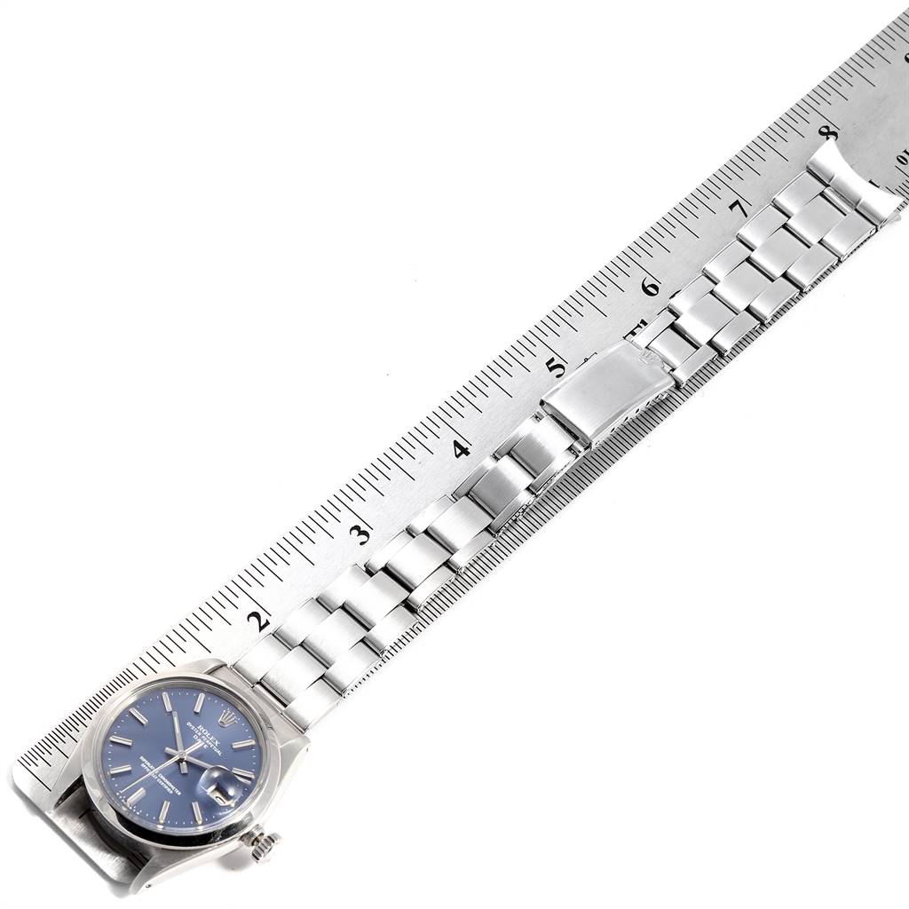 This image shows a Rolex Vintage Collection 1500 Men's Stainless Steel Blue Dial 1500 Men's Stainless Steel Blue Dial watch laid flat next to a ruler, highlighting the bracelet and dial.