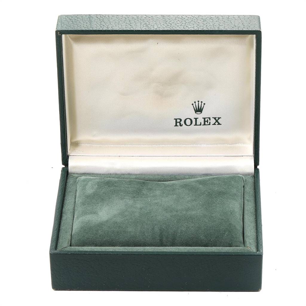 This image shows an open Rolex Vintage Collection 1500 Men's Stainless Steel Blue Dial 1500 Men's Stainless Steel Blue Dial watch box with a green exterior and cushion inside.