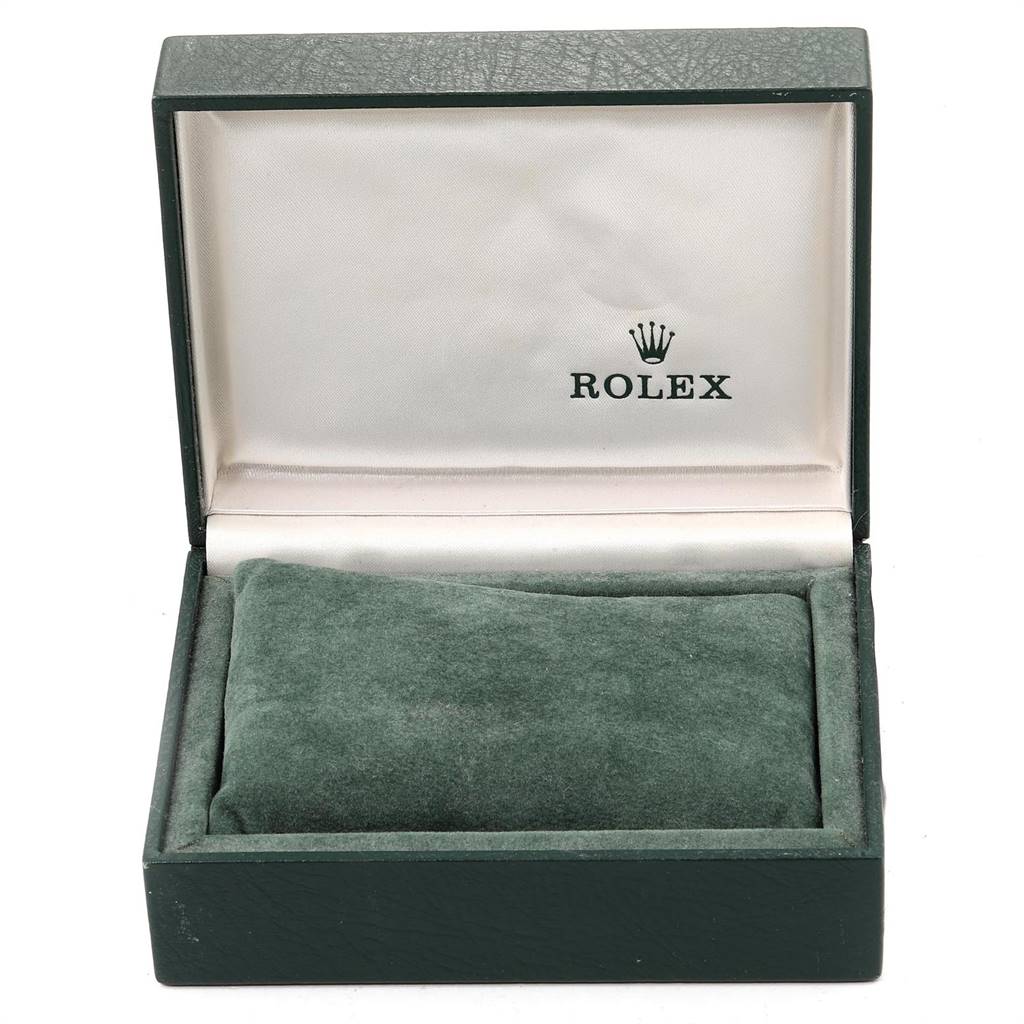 The image shows an open green Rolex box, likely for a Vintage Collection model, with a green velvet cushion inside.