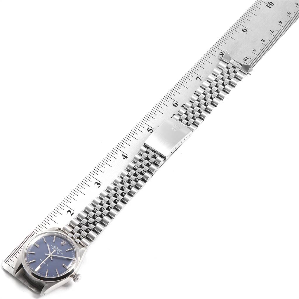 The Rolex Vintage Collection 5500 Men's Stainless Steel Blue Dial 5500 Men's Stainless Steel Blue Dial watch is shown flat, alongside a ruler, displaying the watch face, bracelet, and clasp.