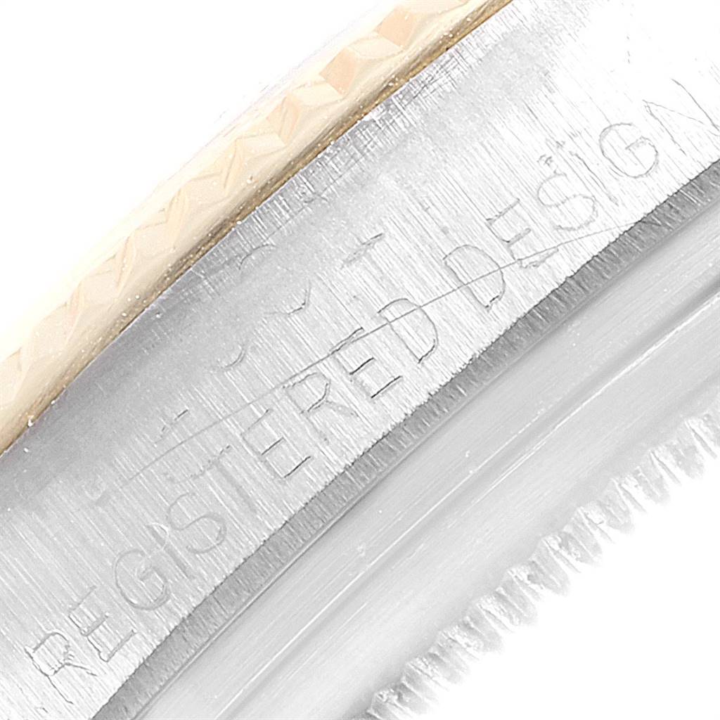 The image shows a close-up angle of the bezel and part of the casing of a Rolex Vintage Collection 1601 Men's Steel and Gold (two tone) Silver Dial 1601 Men's Steel and Gold (two tone) Silver Dial model watch, highlighting the text "REGISTERED DESIGN."