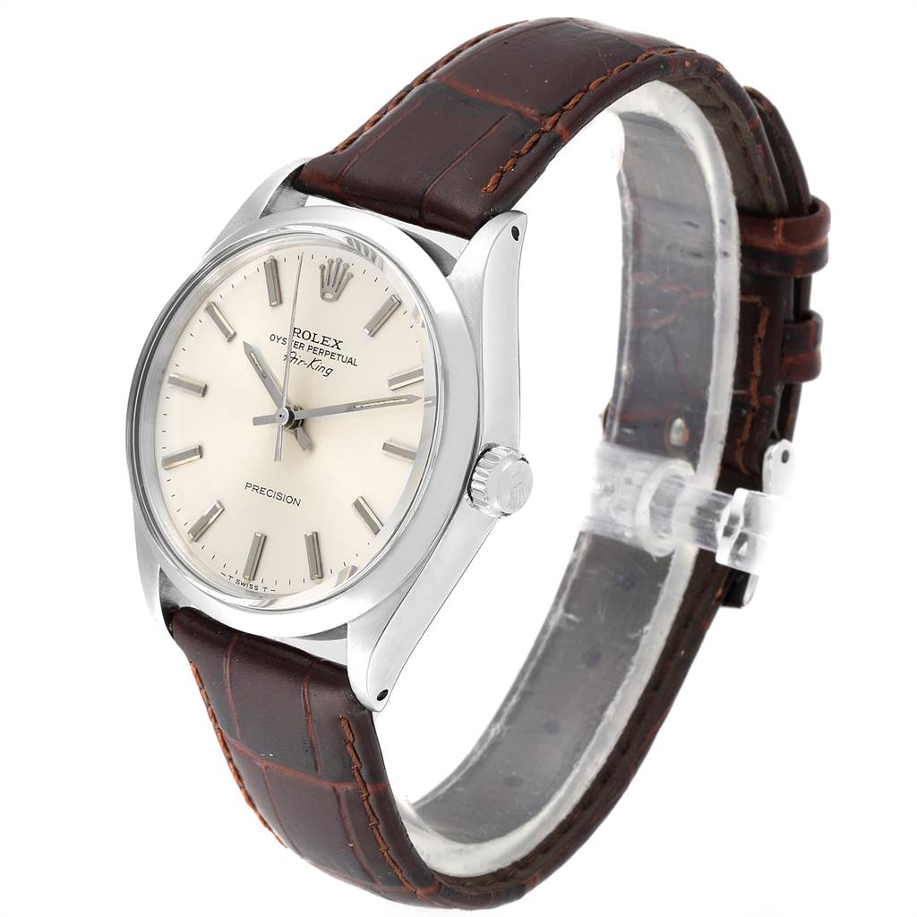 The watch is shown from a three-quarter angle, displaying the face, bezel, crown, and leather strap of the Rolex Oyster Perpetual Vintage Collection.