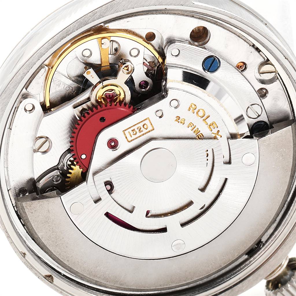 The image shows an inner mechanism view of the Vintage Collection model by Rolex, highlighting gears and movement parts.