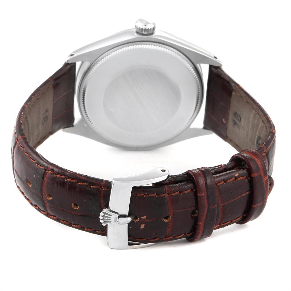 The image shows the back view of a Vintage Collection Rolex watch, highlighting the case back and brown leather strap with a Rolex-branded buckle.